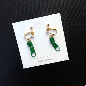Dark green zipper dangle clip-on earrings with gold-tone hardware.