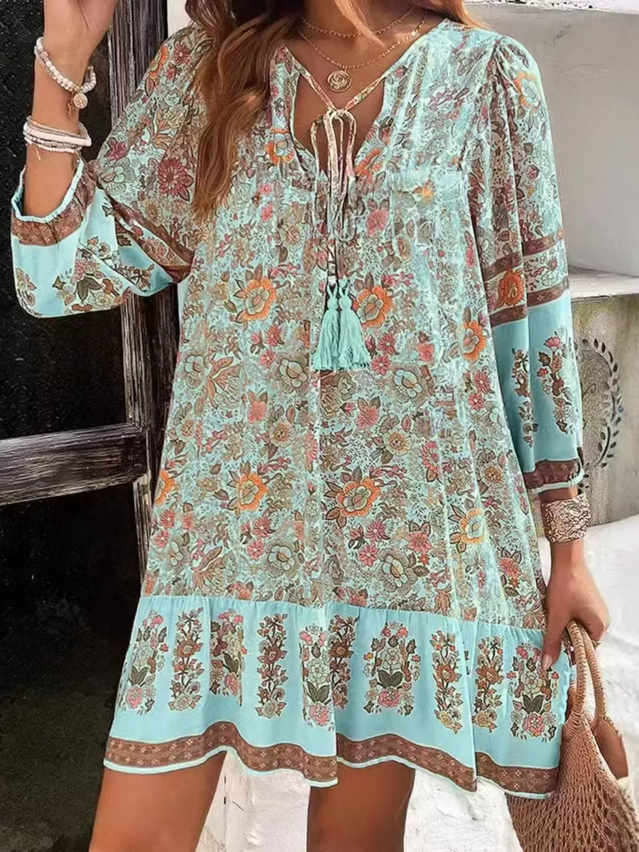 Light blue floral mini dress with tassel tie neckline and tiered hem
