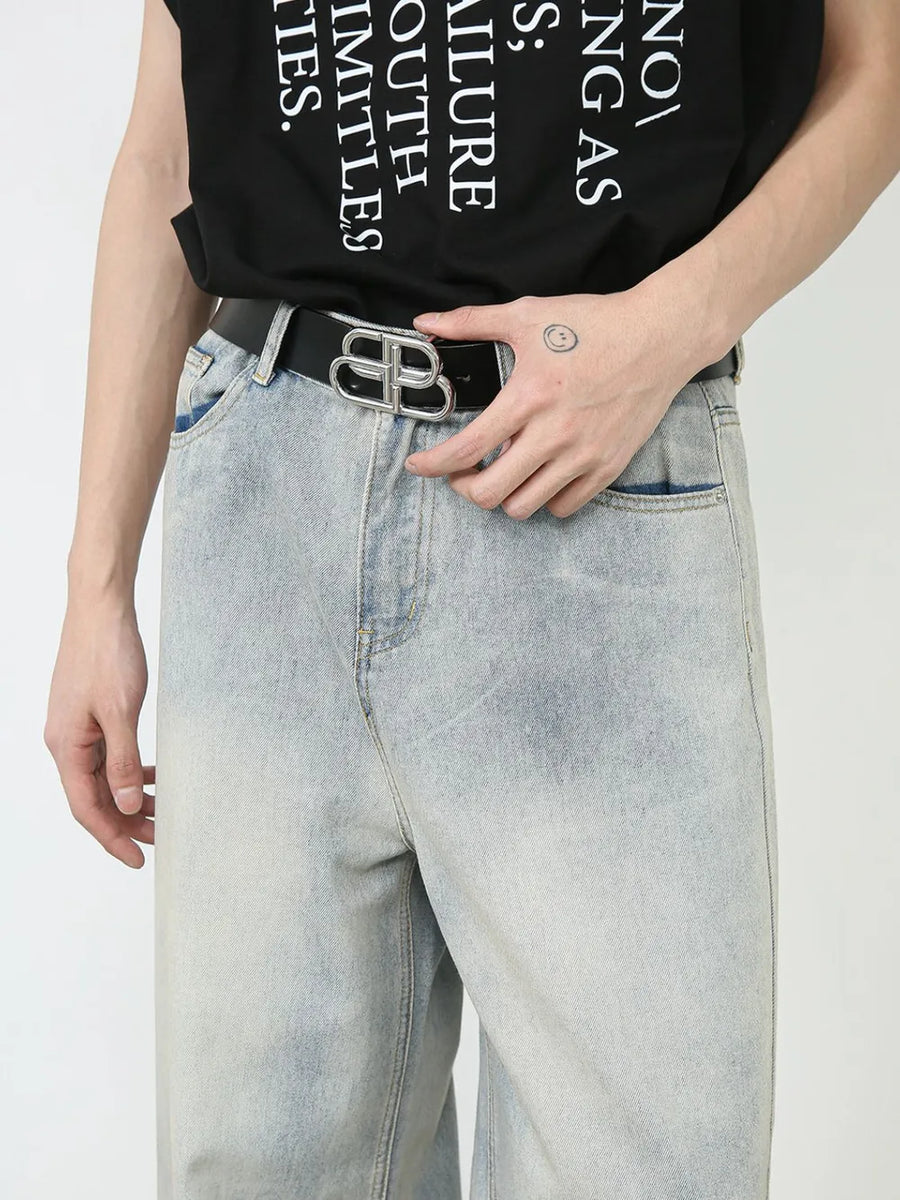 Faded denim palazzo pants in light wash with relaxed, oversized fit.
