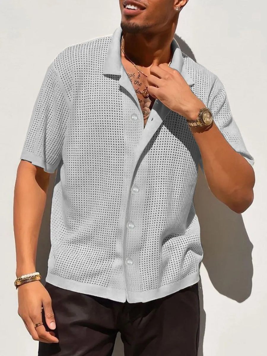 Gray perforated knit resort shirt with short sleeves and a button-up front.