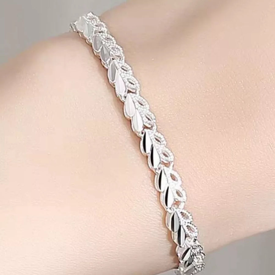 Sterling silver bracelet with interconnected leaf links and sparkling accents.