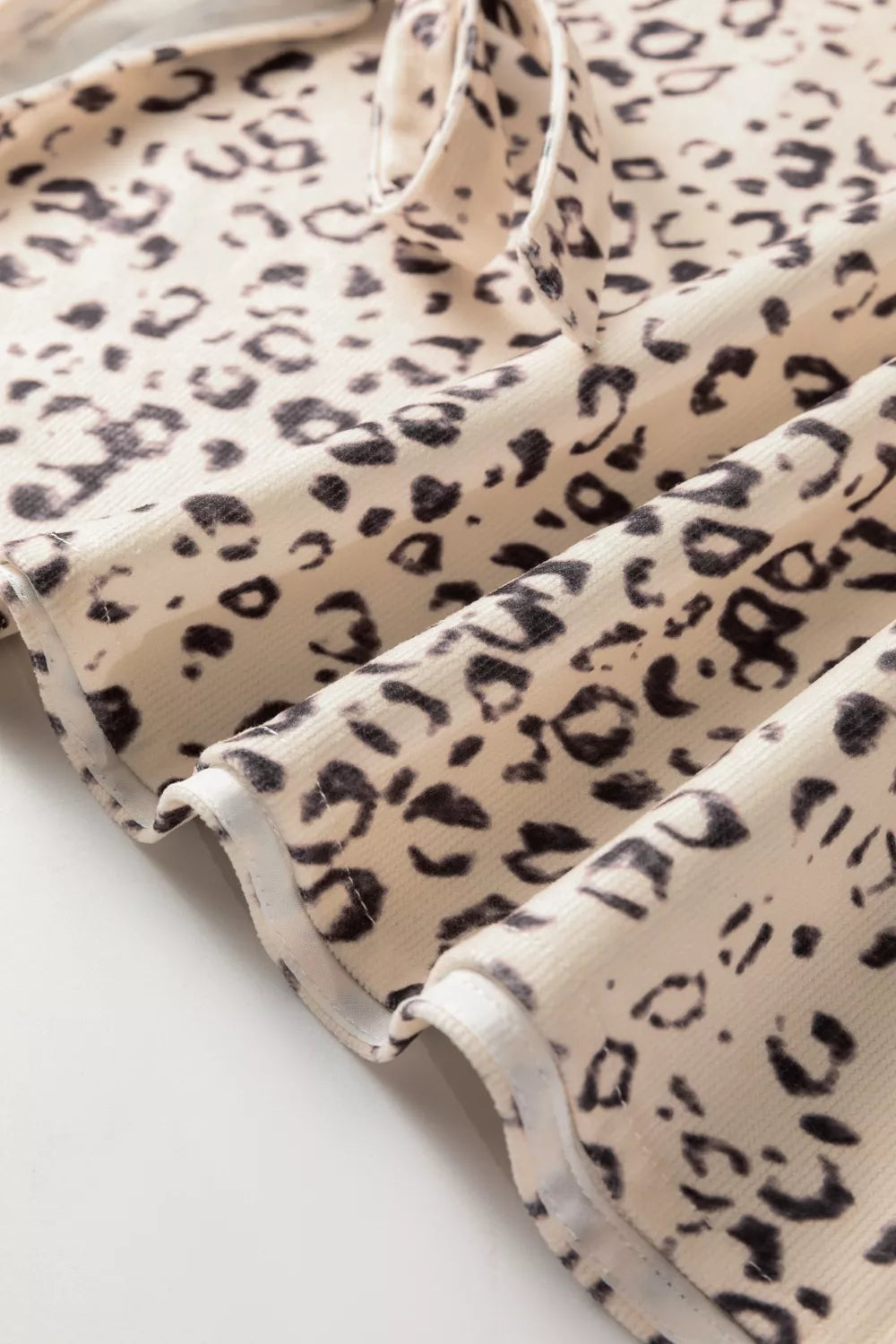 Knot detail leopard print tank top in cream and black animal print.