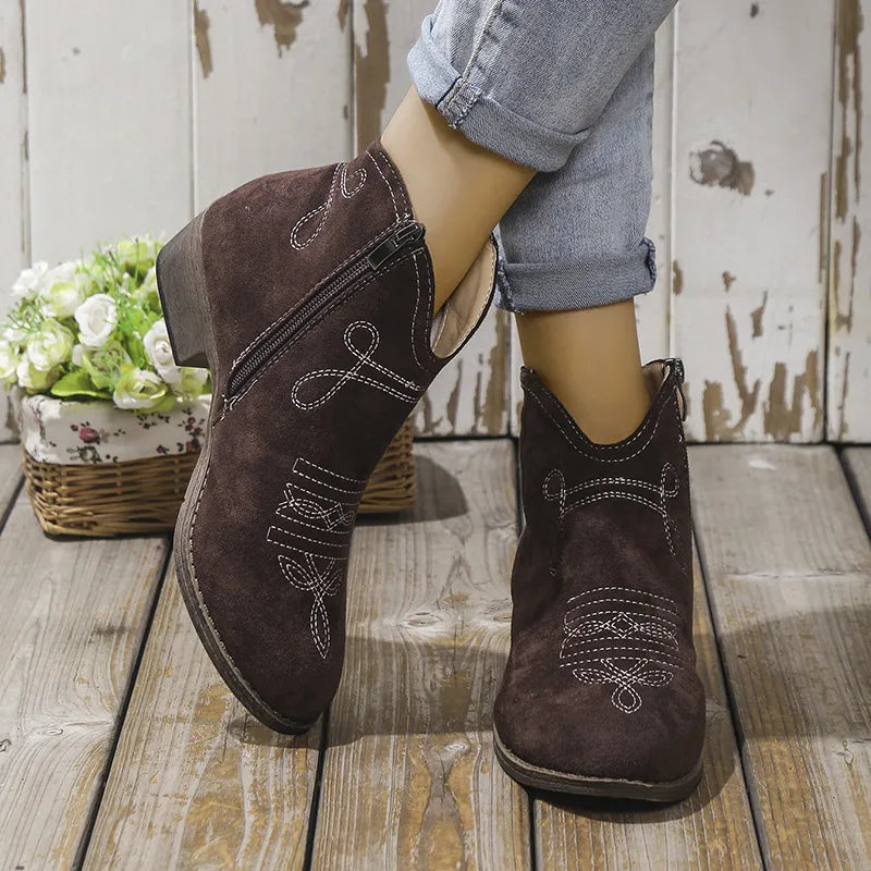 Embroidered suede western ankle boots in chocolate with white stitching detail and side zipper.