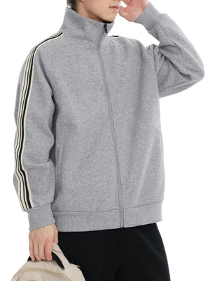 Plus-size grey zip-up sweatshirt with contrast stripe detail on sleeves and mock neck.