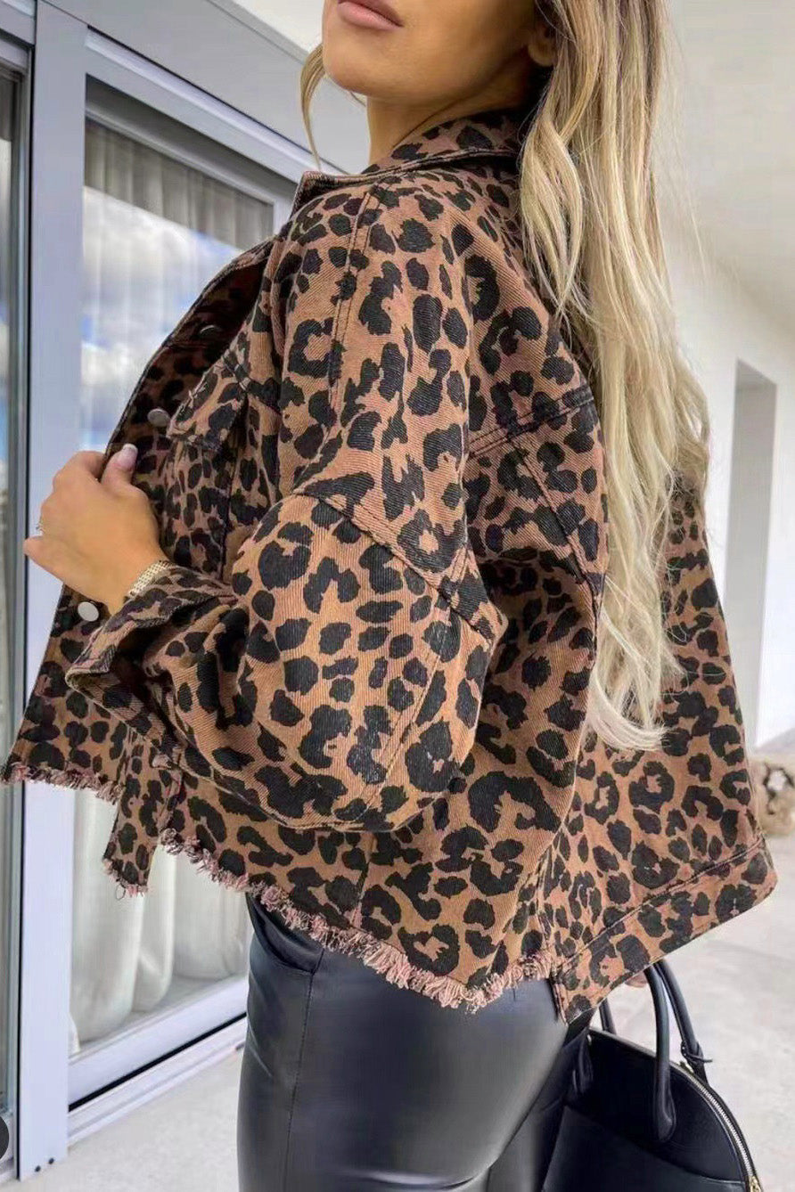 Leopard print denim jacket with frayed hem and buttoned front.