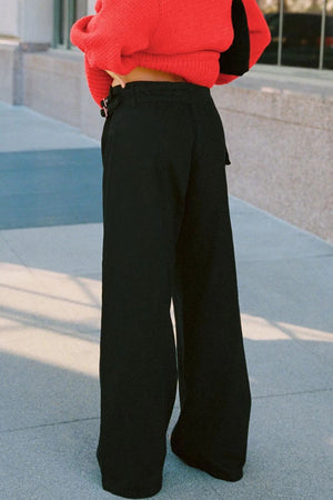Black flared denim trousers with utility buckle detail and wide leg