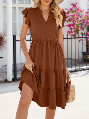 Brown ruffled midi dress with notched V-neck and tiered skirt.