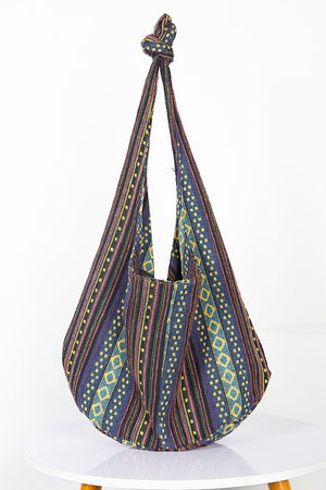 Tribal weave shoulder bag with geometric patterns in blue, purple, and yellow.
