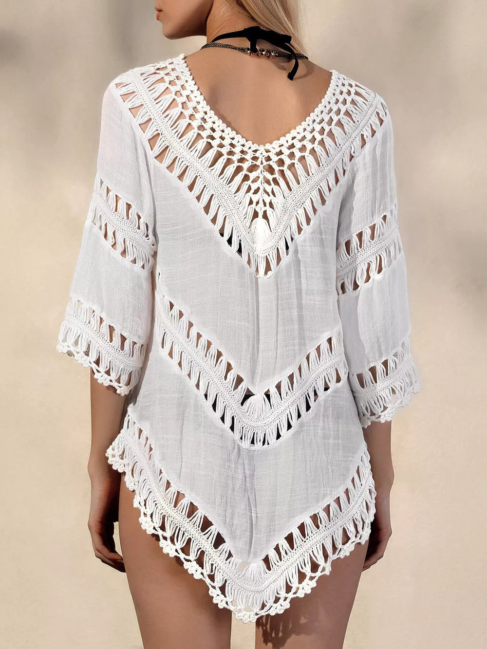 White chevron crochet V-neck cover-up with fringe details and cutout sleeves.