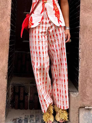Red fish print two-piece set with wide leg pants and a peplum top.