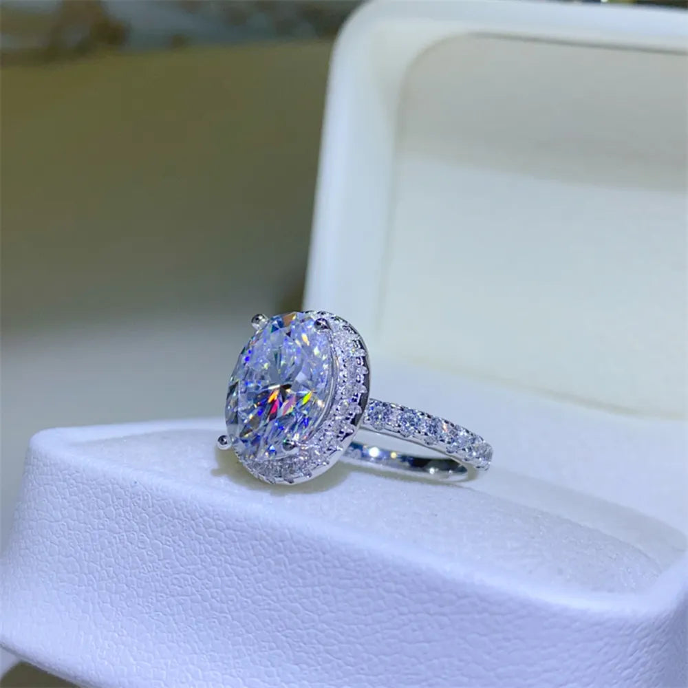 Silver oval halo moissanite engagement ring with pave band