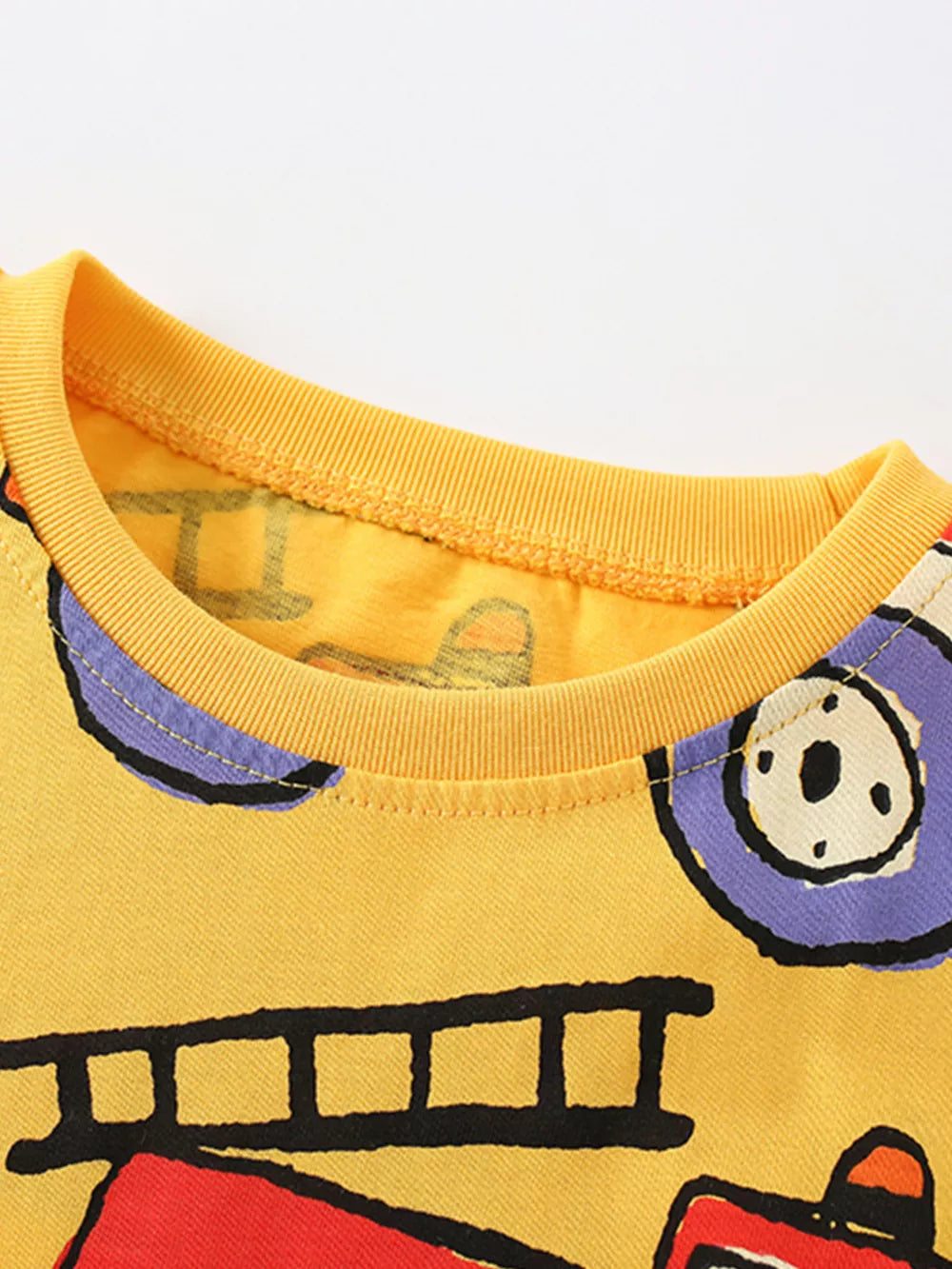 Yellow toddler t-shirt with all-over fire truck print and crew neck.