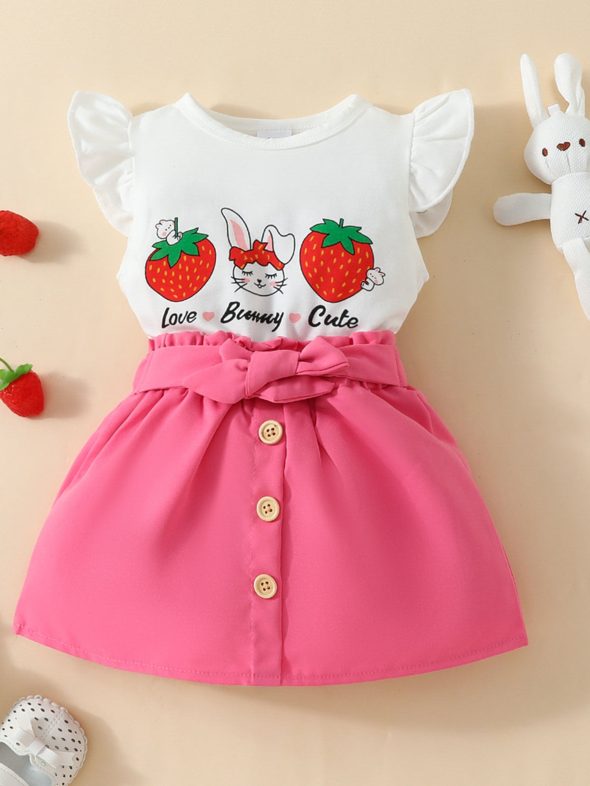 Baby girl set with white bunny strawberry graphic tee and pink button-front skirt with bow