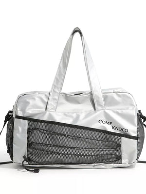 Sleek silver duffel bag with mesh pockets and adjustable strap.