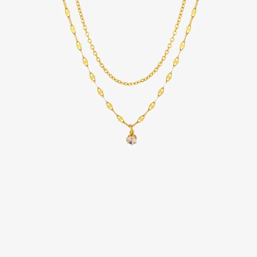 Gold layered necklace with delicate chain and single clear stone pendant