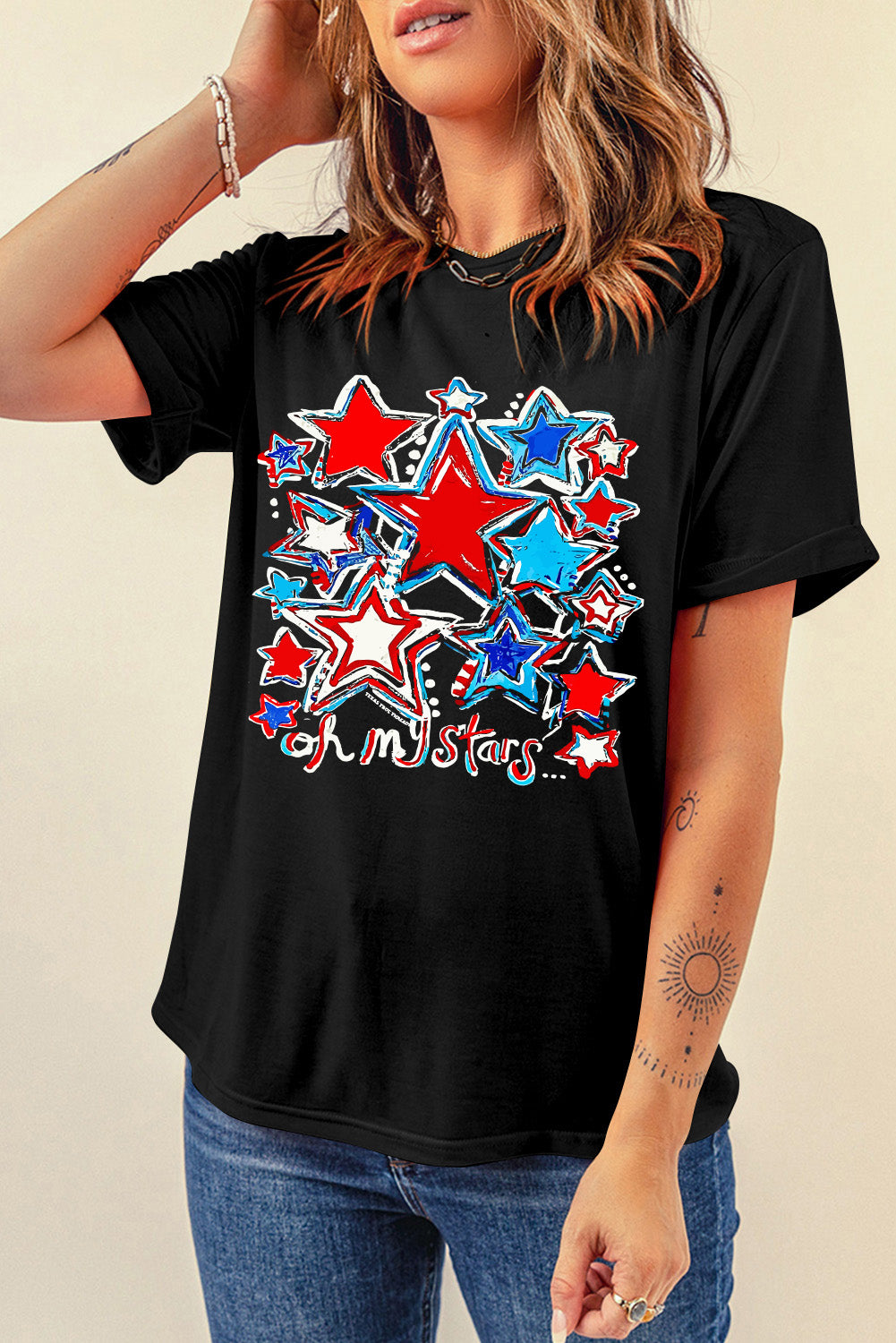 Black t-shirt with rolled sleeves and a red, white, and blue starburst graphic that says "oh my stars".