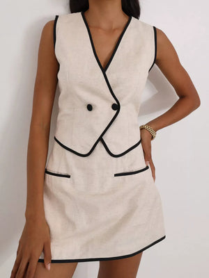 Cream linen blend sleeveless mini dress with black trim and double button detail
