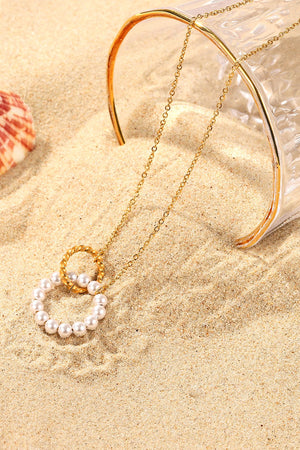 Gold chain necklace with pearl and twisted circle pendant