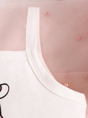 White cotton baby tank top with cow print detail and pink tulle overlay.