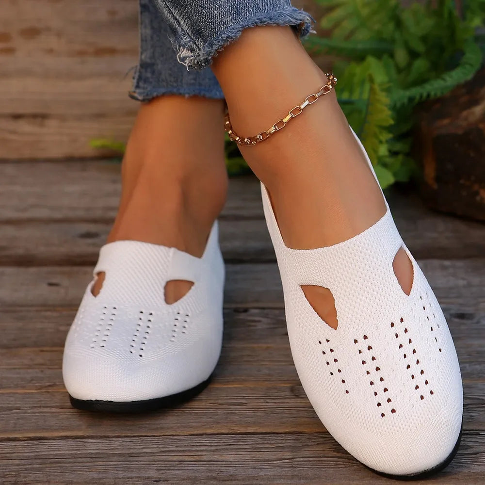 White knit slip-on flats with cutout details and perforated toe box.