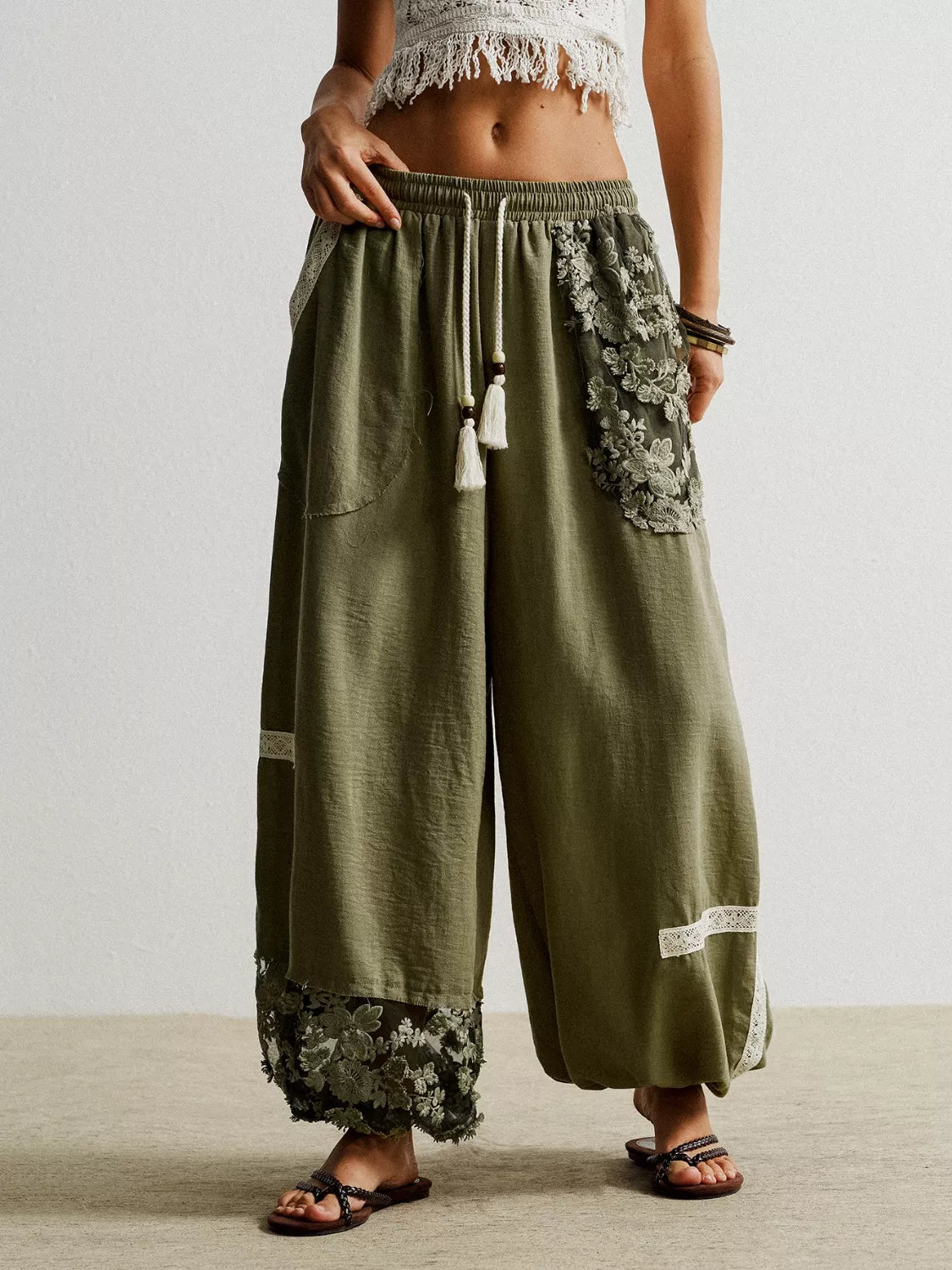 Moss harem pants with drawstring, lace trim, and tassels.