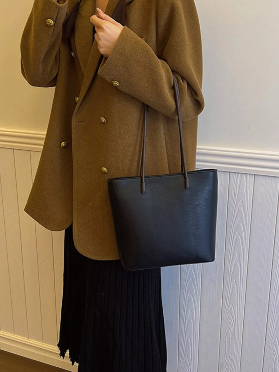 Sleek black PU leather shoulder tote bag with thin straps.