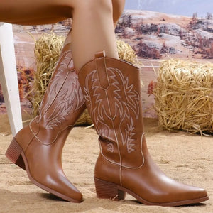 Brown leather mid-calf boots with white western-inspired embroidery and block heels.