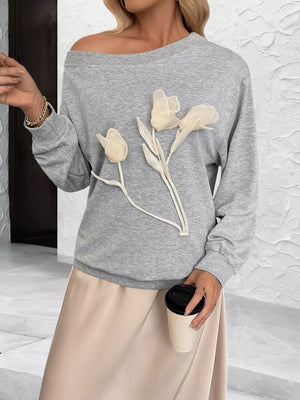 Gray boat neck sweater with floral applique detail