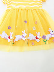 Yellow tulle baby dress with embroidered bunnies and flowers.
