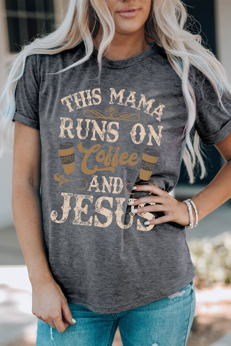 Graphic tee in mid gray with "This Mama Runs on Coffee and Jesus" text and coffee cup graphics.