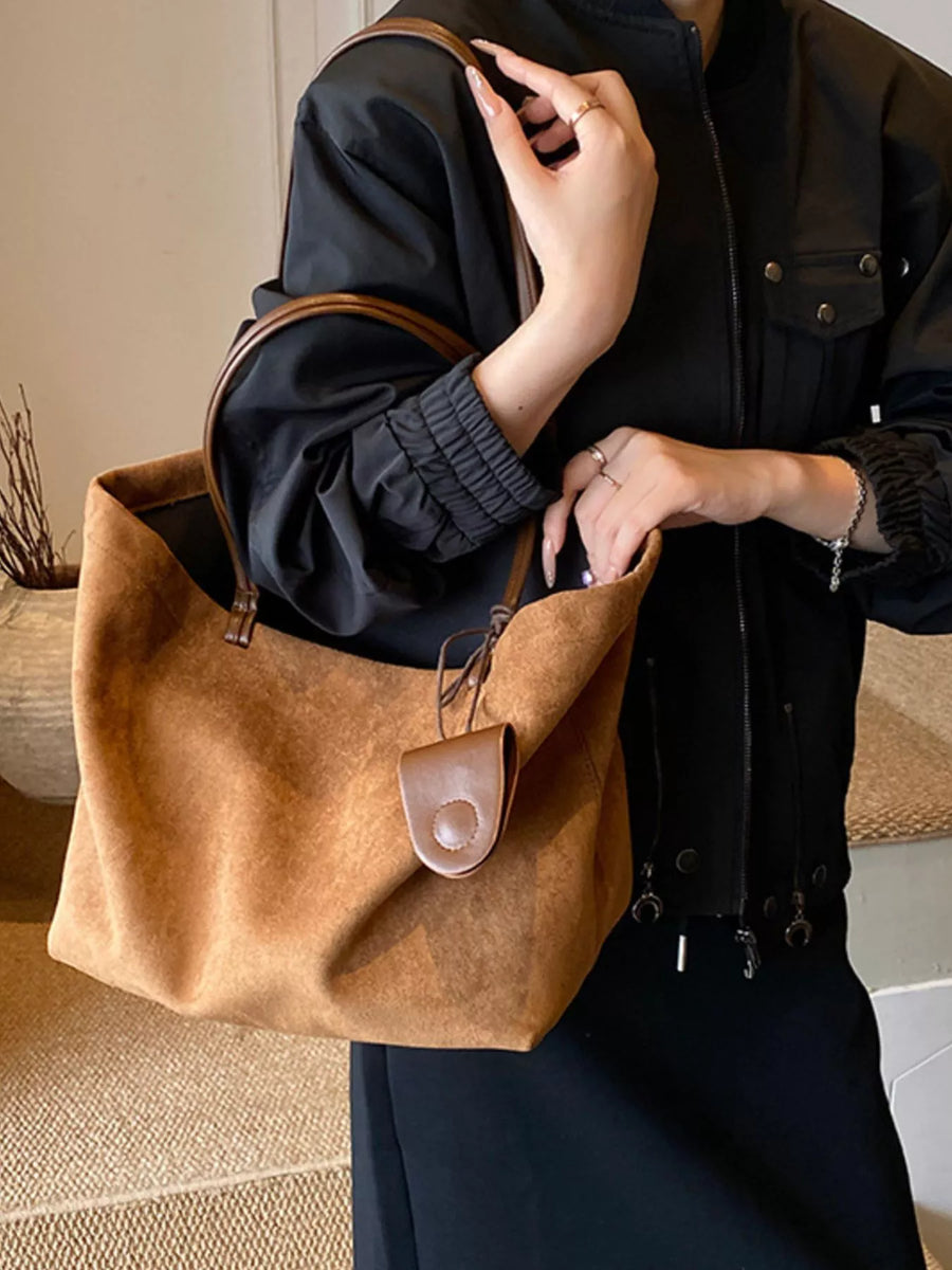Large caramel brown suede tote bag with leather trim and a small snap closure pouch.