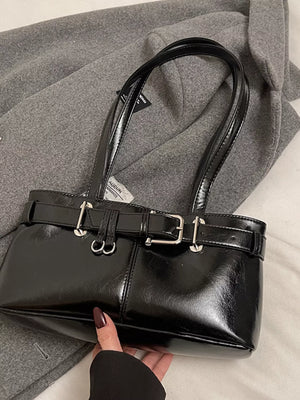 Black patent shoulder bag with buckle detail and silver hardware.