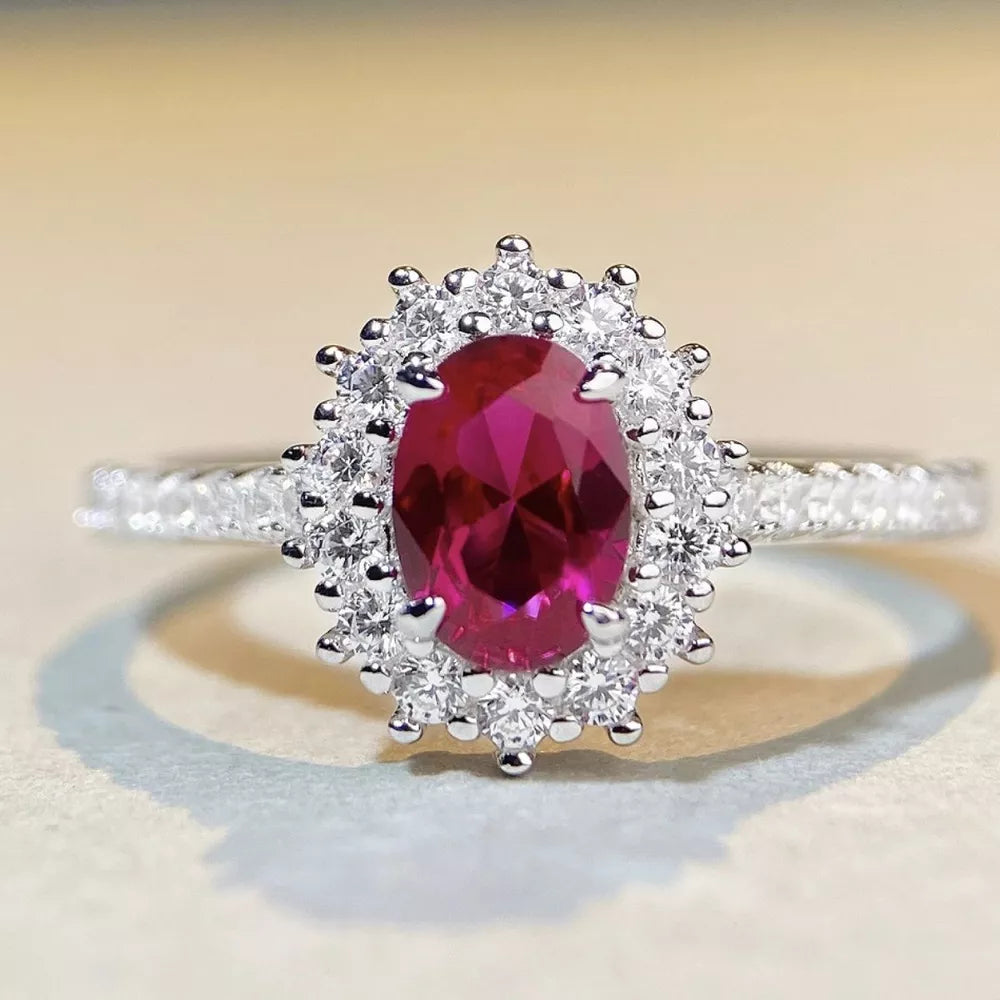 ring in ruby red featuring halo setting and fitted fit