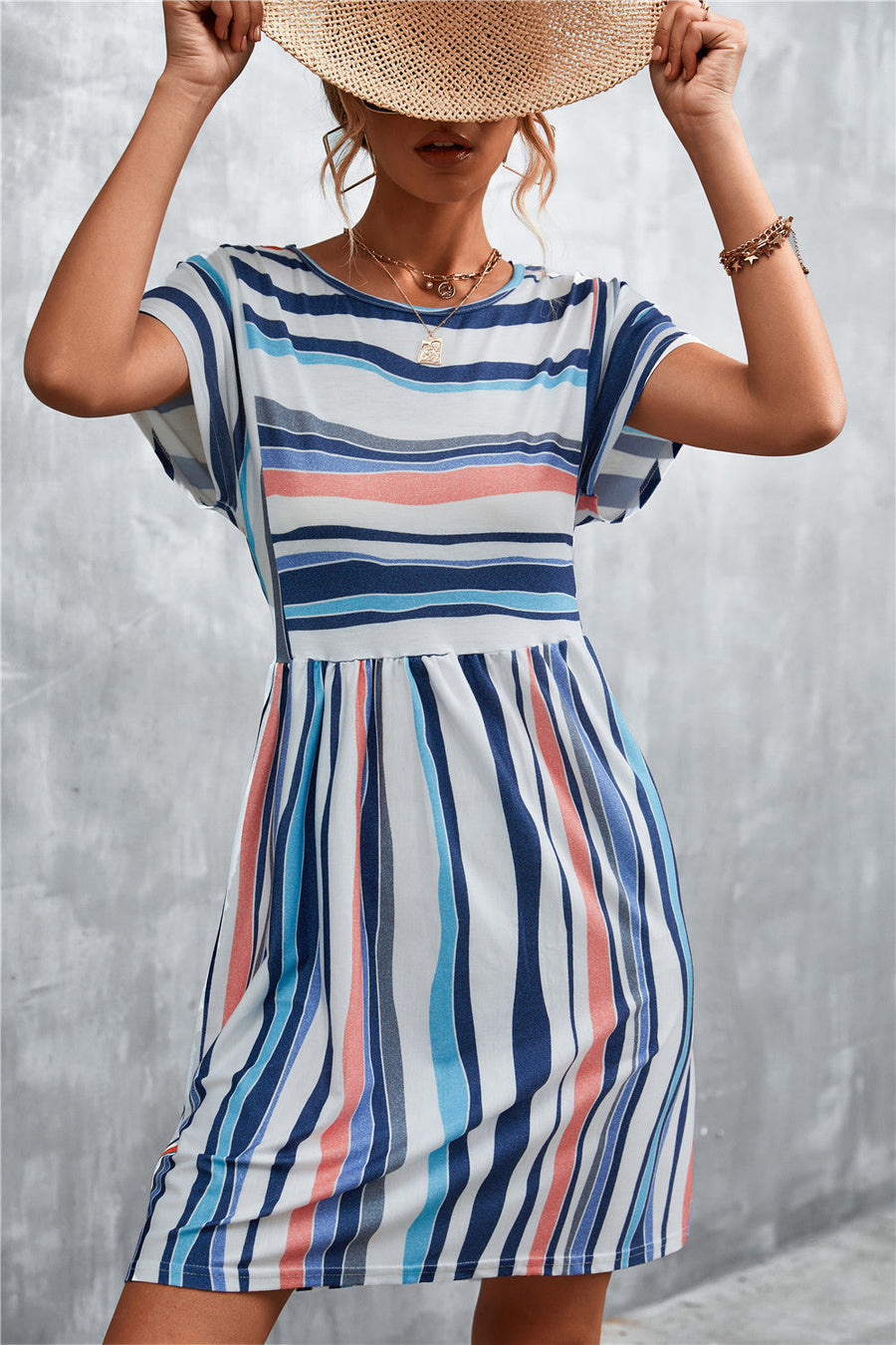 Striped yoke-seam trapeze dress with short sleeves and a gathered waist.