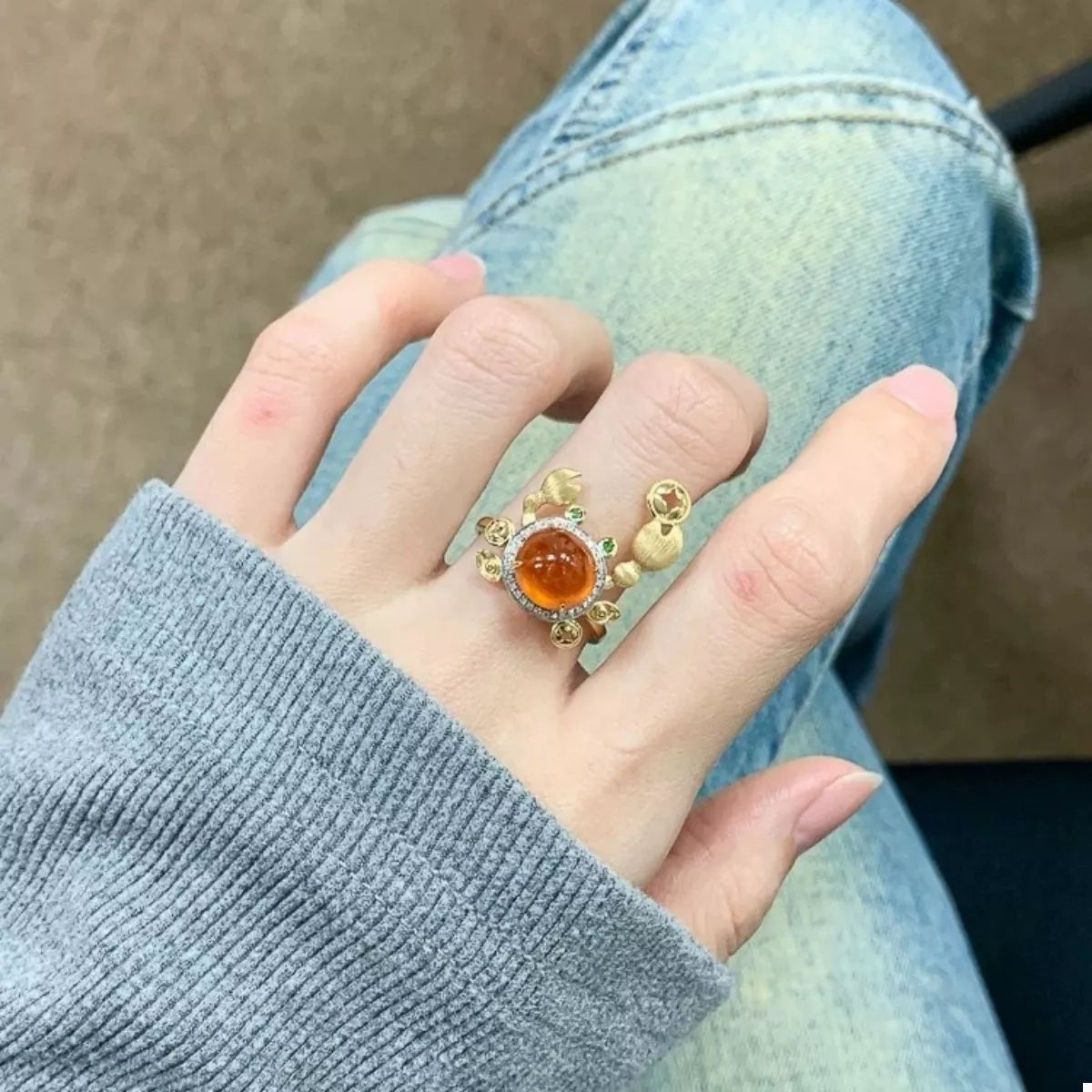 Gold crab ring with orange gemstone and diamond accents