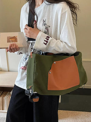 Green nylon crossbody bag with contrast tan pocket and strap detail