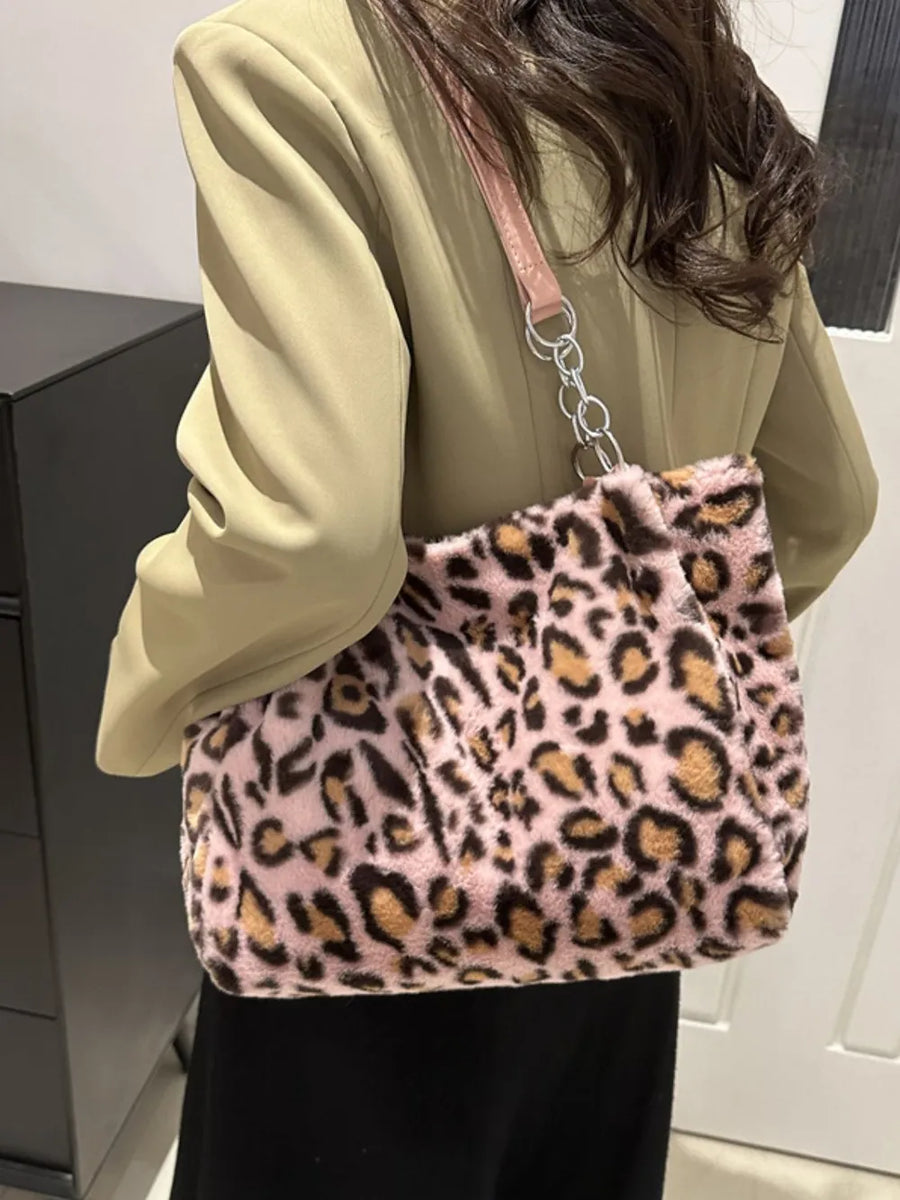 Pink leopard print faux fur tote bag with chain handle detail.