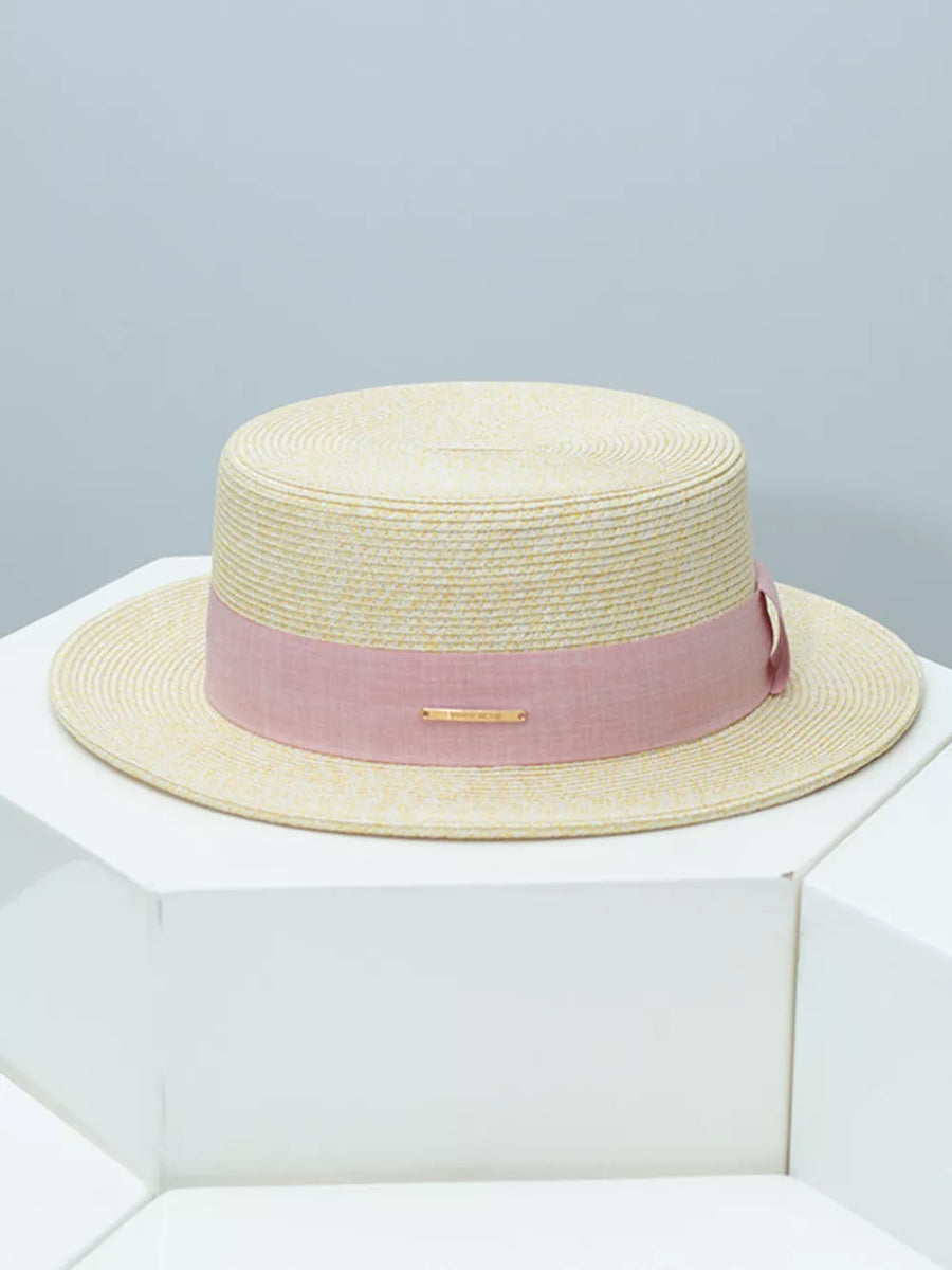 Straw boater hat in beige with a blush pink ribbon band and gold detail