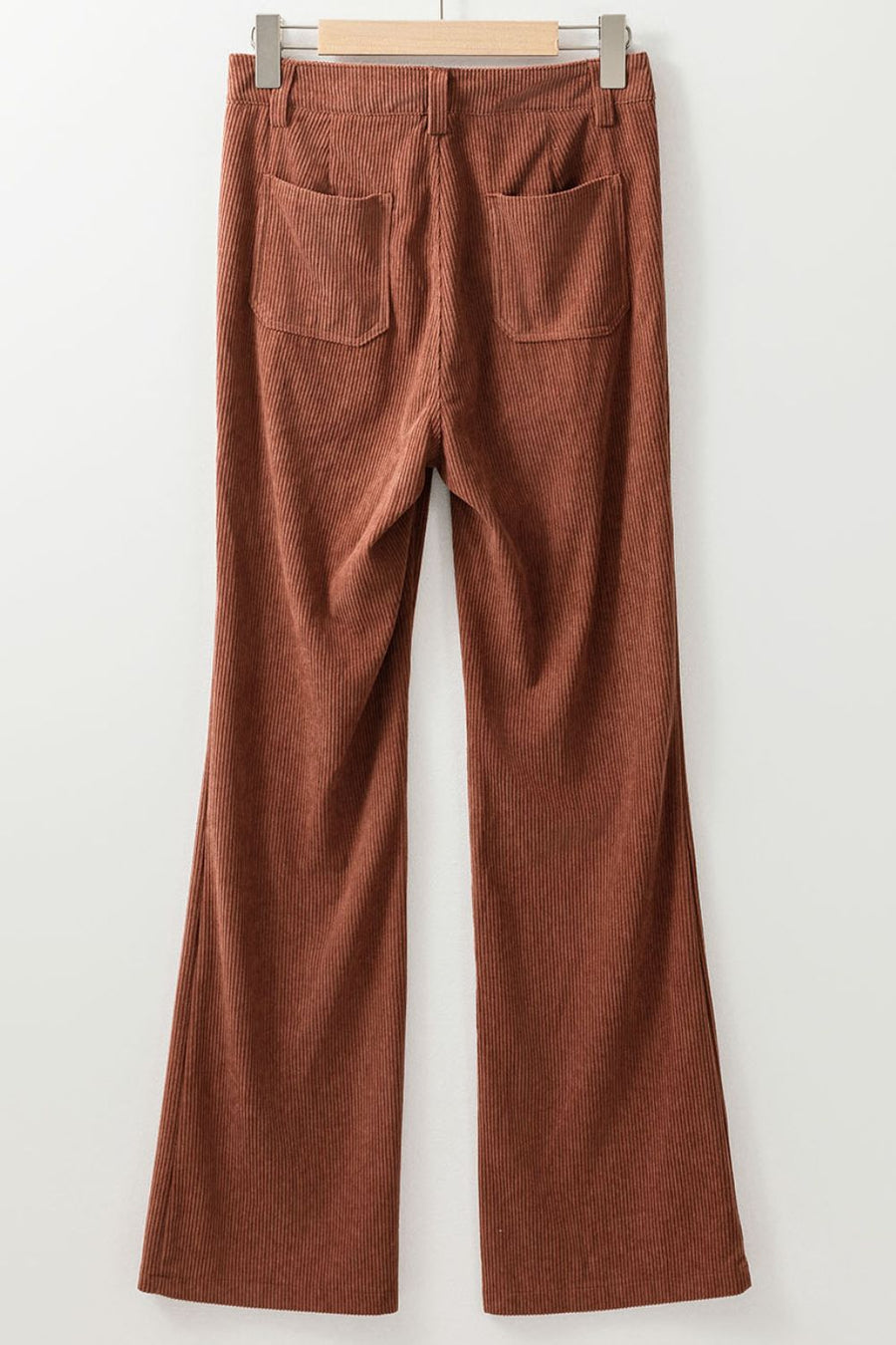 Brown corduroy flared leg trousers with back pockets.