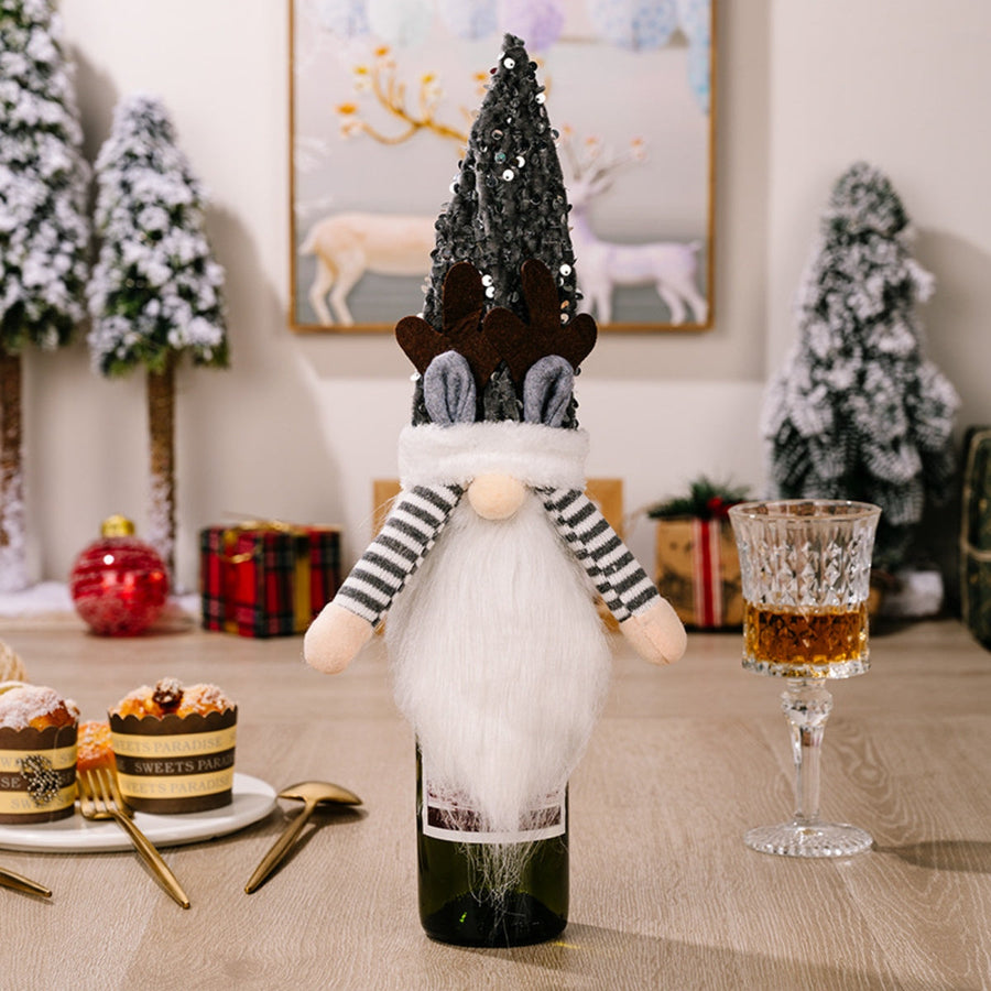Festive gnome bottle topper with antlers and striped sleeves, dark gray sequin hat.