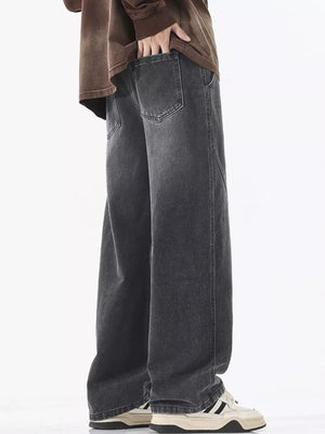 Relaxed fit wide-leg jeans in dark gray denim with drawstring waist detail.
