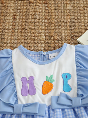Baby girl's blue gingham dress with carrot embroidery and puff sleeves.