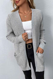Light gray waffle knit longline cardigan with pockets, open front and long sleeves.