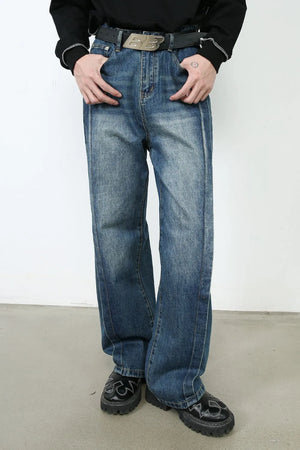 Medium wash denim jeans with vertical seams and wide legs.