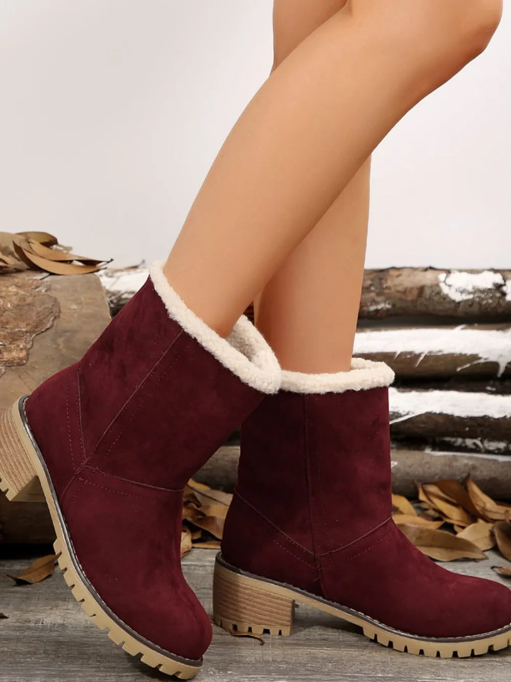 Burgundy suede ankle boots with sherpa trim and block heel.