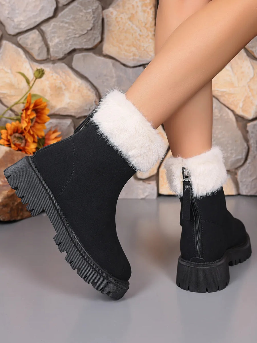 Black suede ankle boots with white faux fur trim and side zipper detail.