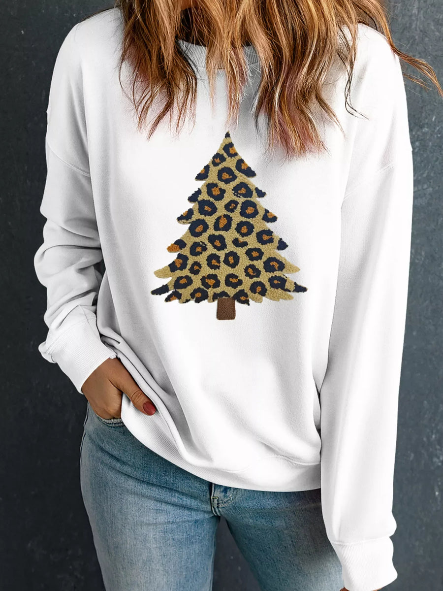 White drop shoulder sweatshirt with a leopard print Christmas tree graphic.