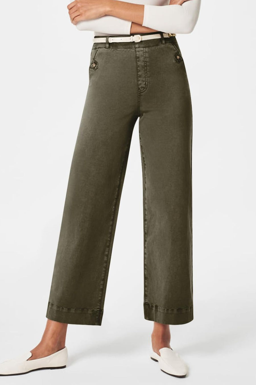 Wide-leg utility denim trousers in olive brown with button details and a white belt.