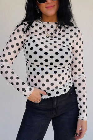 White polka dot mesh mock neck shirt with lettuce trim sleeves and hem