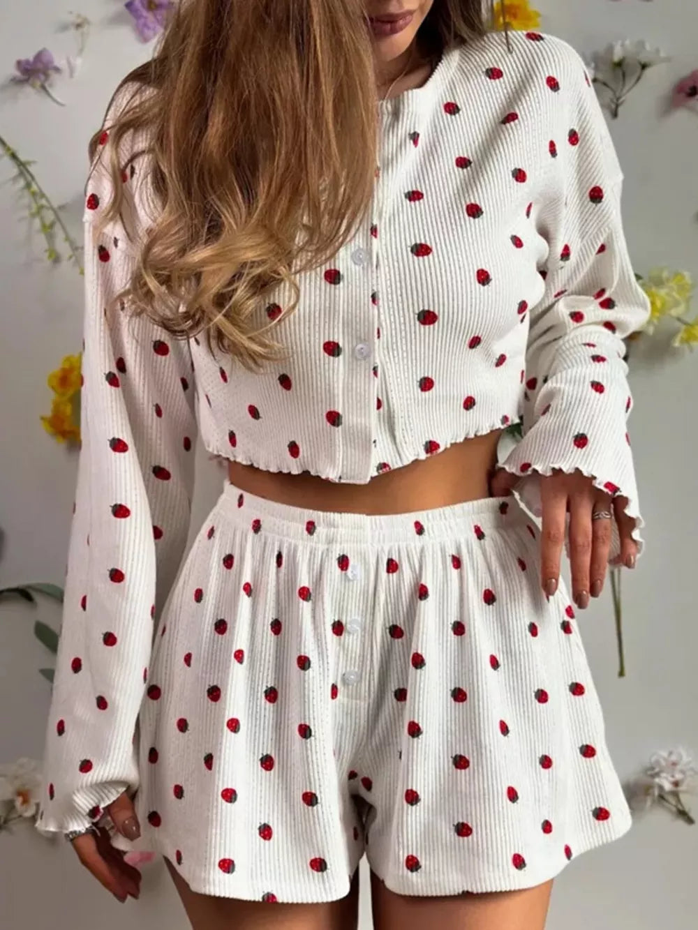 White strawberry print pajama set with cropped button-down top and shorts.